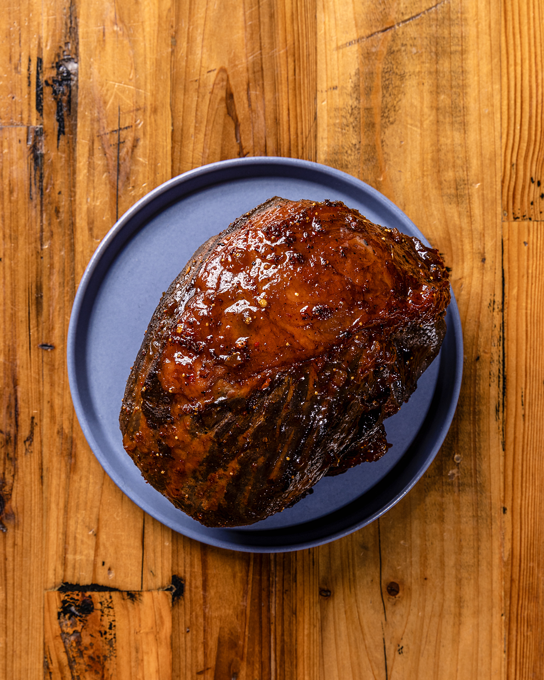 Glazed holiday ham on a blue plate