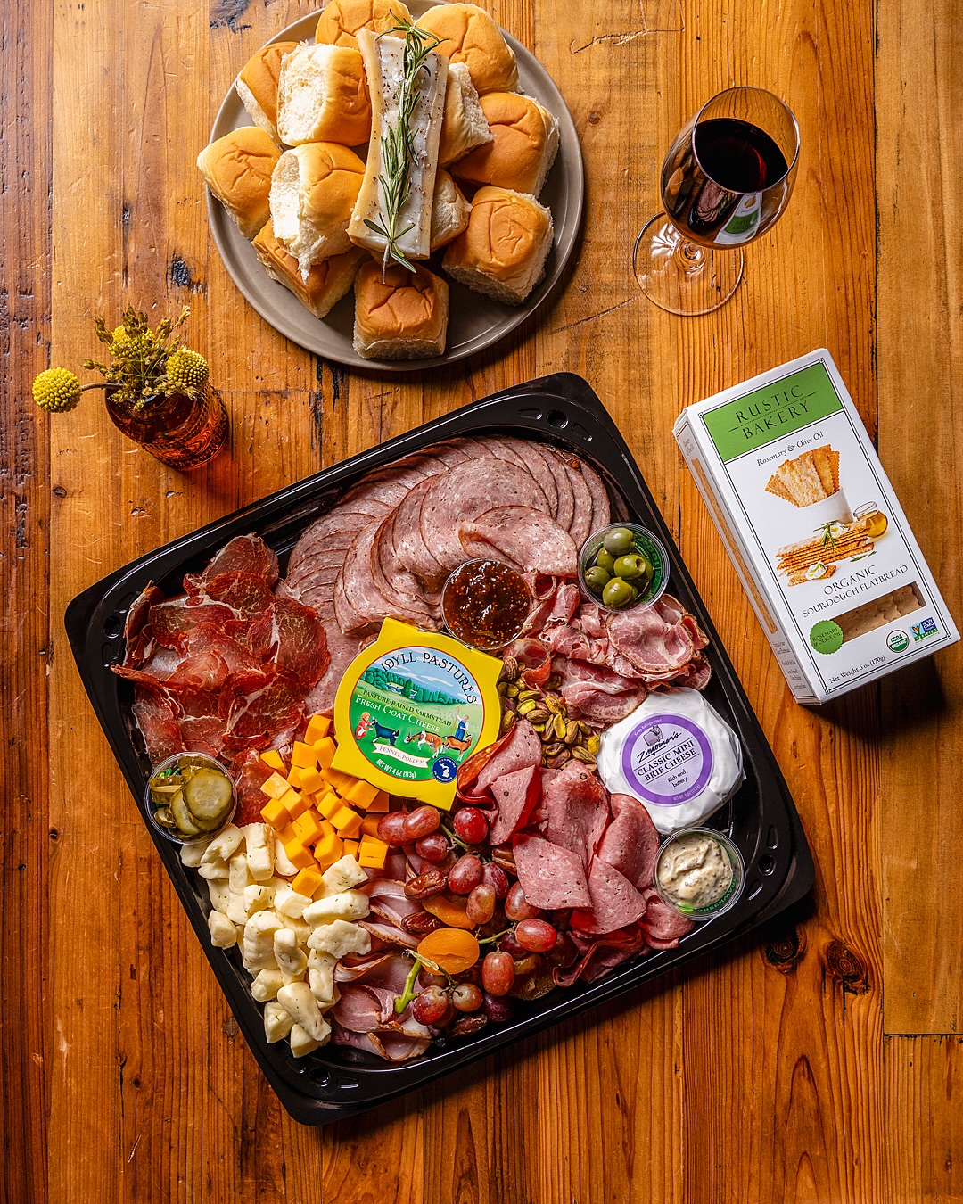 Charcuterie board with cured meats, cheeses, pickles, and crackers